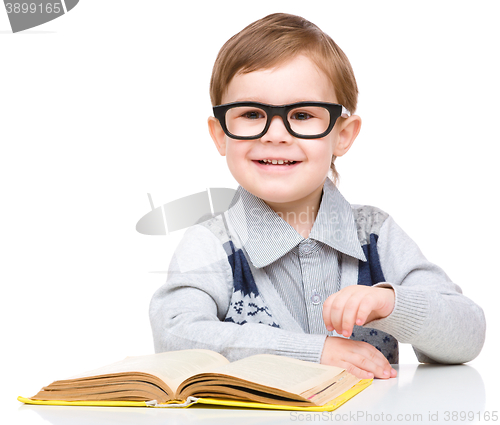 Image of Little child play with book