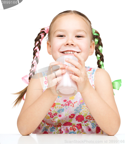 Image of Cute little girl showing milk moustache