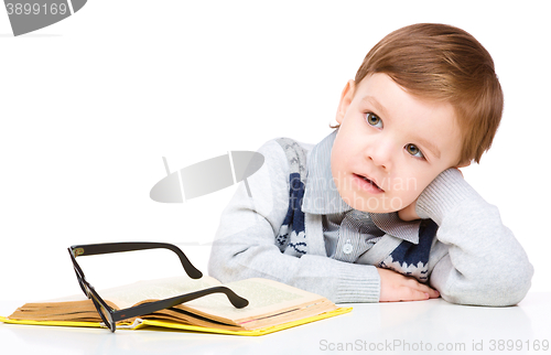 Image of Little child play with book