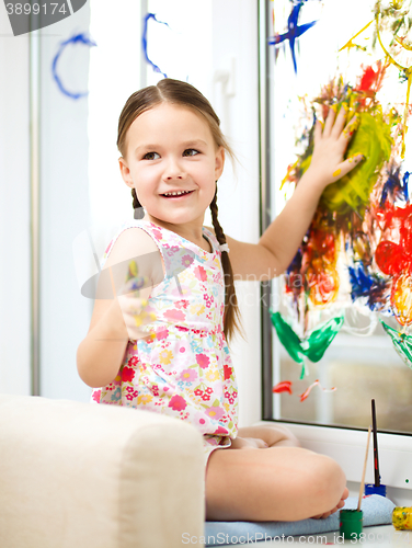 Image of Portrait of a cute girl playing with paints