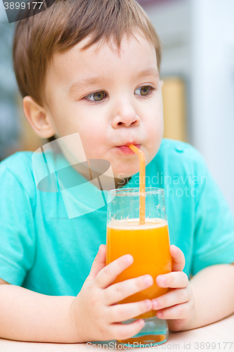 Image of Little boy with glass of orange juice