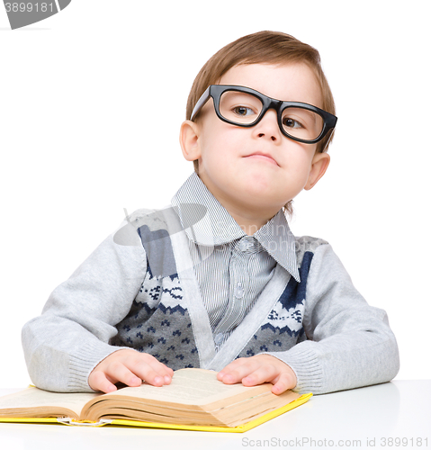 Image of Little child play with book