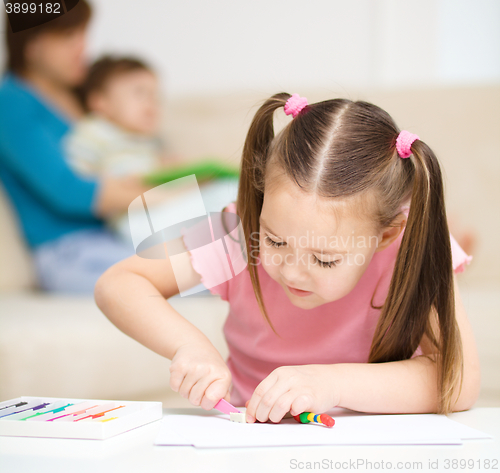 Image of Little girl is playing with plasticine