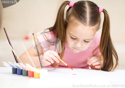 Image of Cute cheerful child play with paints