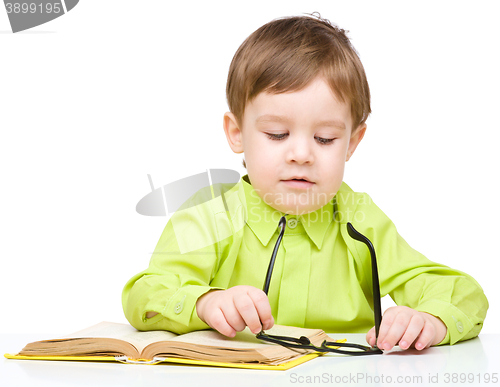 Image of Little child play with book