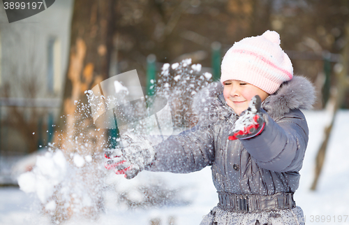 Image of Little girl is throwing snow