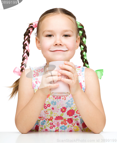 Image of Cute little girl showing milk moustache
