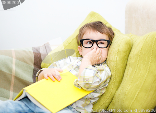 Image of Little boy is reading book