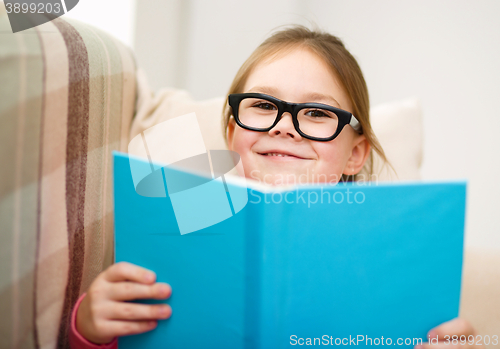 Image of Little girl is reading a book