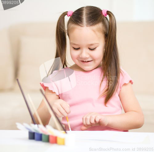 Image of Cute cheerful child play with paints