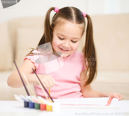 Image of Cute cheerful child play with paints