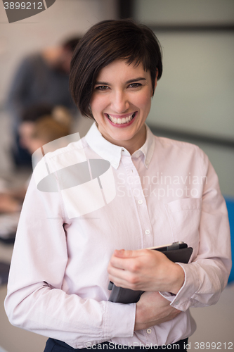 Image of hispanic businesswoman with tablet at meeting room