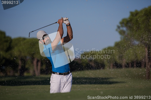 Image of pro golfer hitting a sand bunker shot