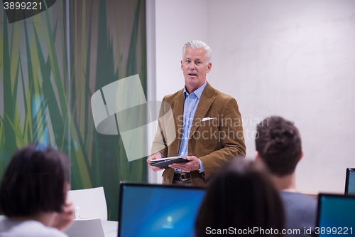 Image of teacher and students in computer lab classroom