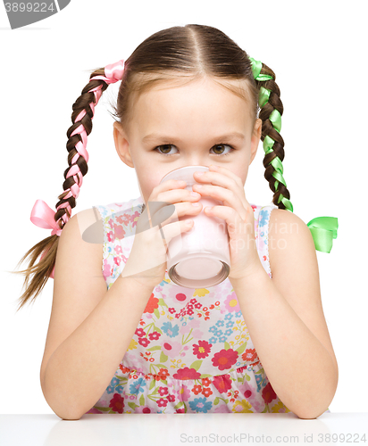 Image of Cute little girl with a glass of milk