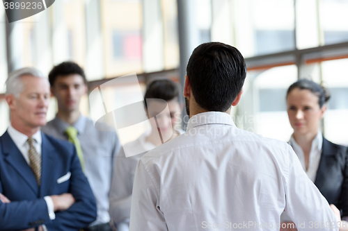 Image of young startup businessman making presentation to senior investio