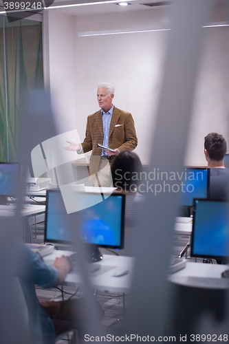 Image of teacher and students in computer lab classroom