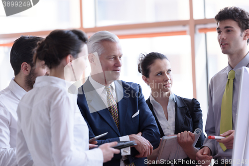 Image of young startup businessman making presentation to senior investio