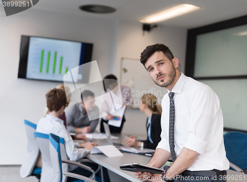 Image of young business man with tablet at office meeting room