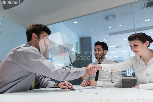 Image of young couple signing contract documents on partners back