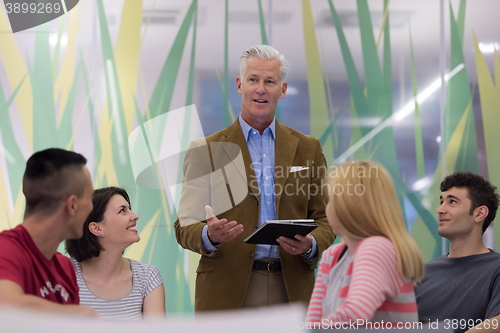 Image of teacher with a group of students in classroom