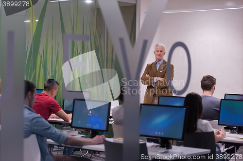 Image of teacher and students in computer lab classroom