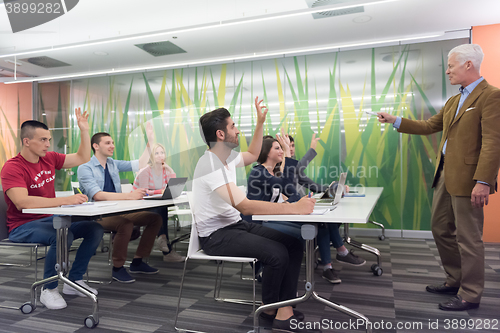 Image of teacher with a group of students in classroom