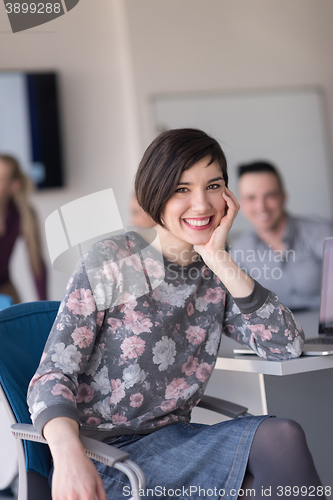 Image of portrait of young business woman at office with team on meeting 