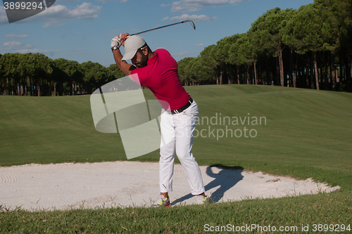 Image of golfer hitting a sand bunker shot