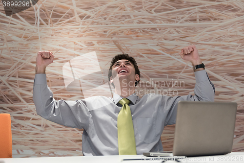 Image of young business man  working on laptop  computer at modern office