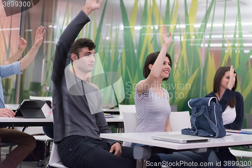 Image of students group raise hands up