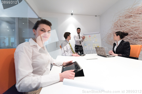 Image of business people group brainstorming and taking notes to flip boa