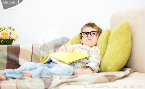 Image of Little boy is reading book