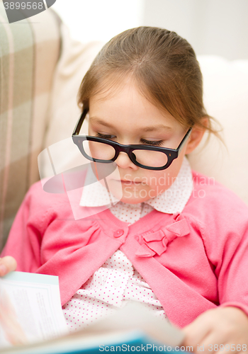 Image of Little girl is reading a book