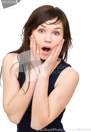 Image of Woman is holding her face in astonishment