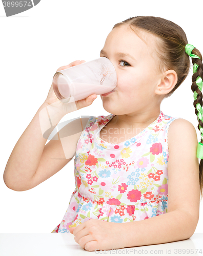 Image of Cute little girl with a glass of milk