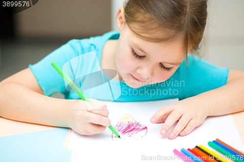 Image of Cute cheerful child drawing using felt-tip pen