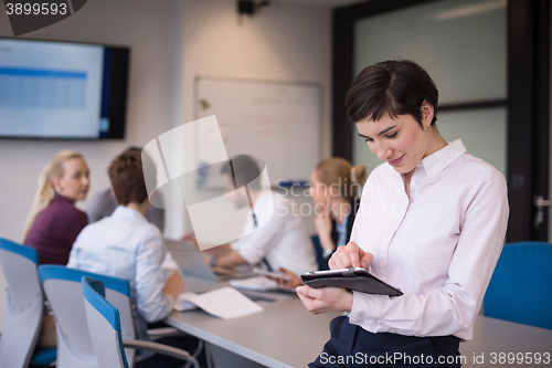 Image of business woman on meeting  using tablet