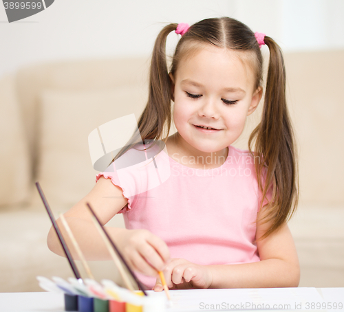 Image of Cute cheerful child play with paints