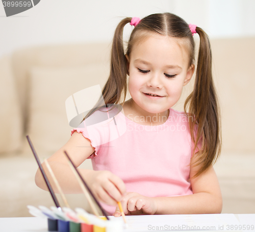 Image of Cute cheerful child play with paints