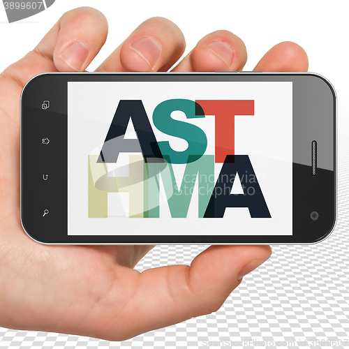 Image of Health concept: Hand Holding Smartphone with Asthma on  display