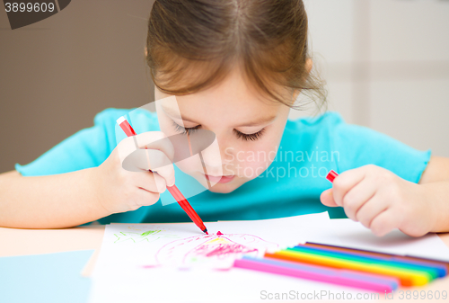 Image of Cute cheerful child drawing using felt-tip pen