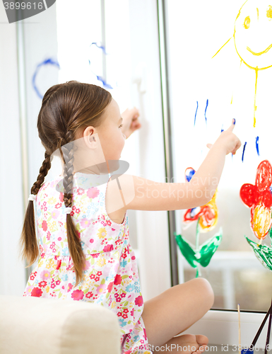 Image of Portrait of a cute girl playing with paints