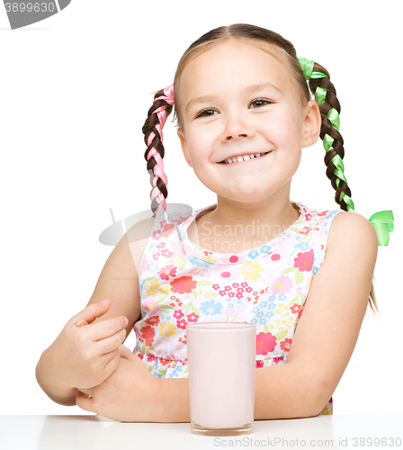 Image of Cute little girl with a glass of milk