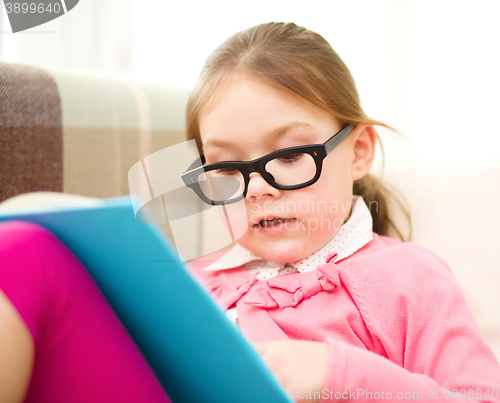 Image of Little girl is reading a book