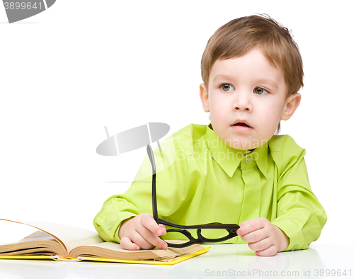 Image of Little child play with book