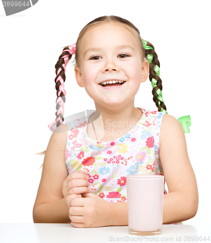 Image of Cute little girl with a glass of milk