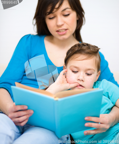 Image of Mother is reading book with her daughter