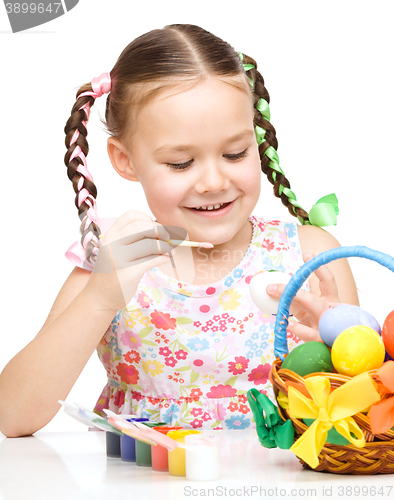 Image of Little girl preparing eggs for Easter