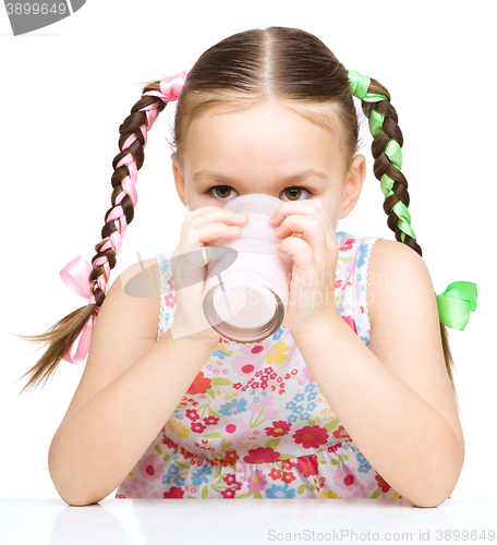 Image of Cute little girl with a glass of milk